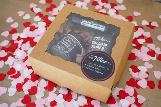 Tallow Chapstick packaging on a wooden surface with decorative garland