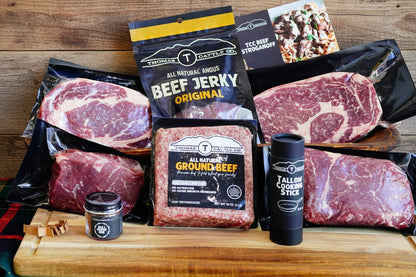 Assorted meats and a cooler bag on a table with a white background