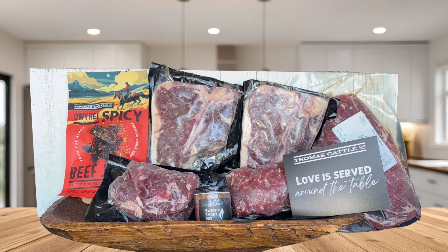 Assorted raw beef packages on a wooden tray with a kitchen background
